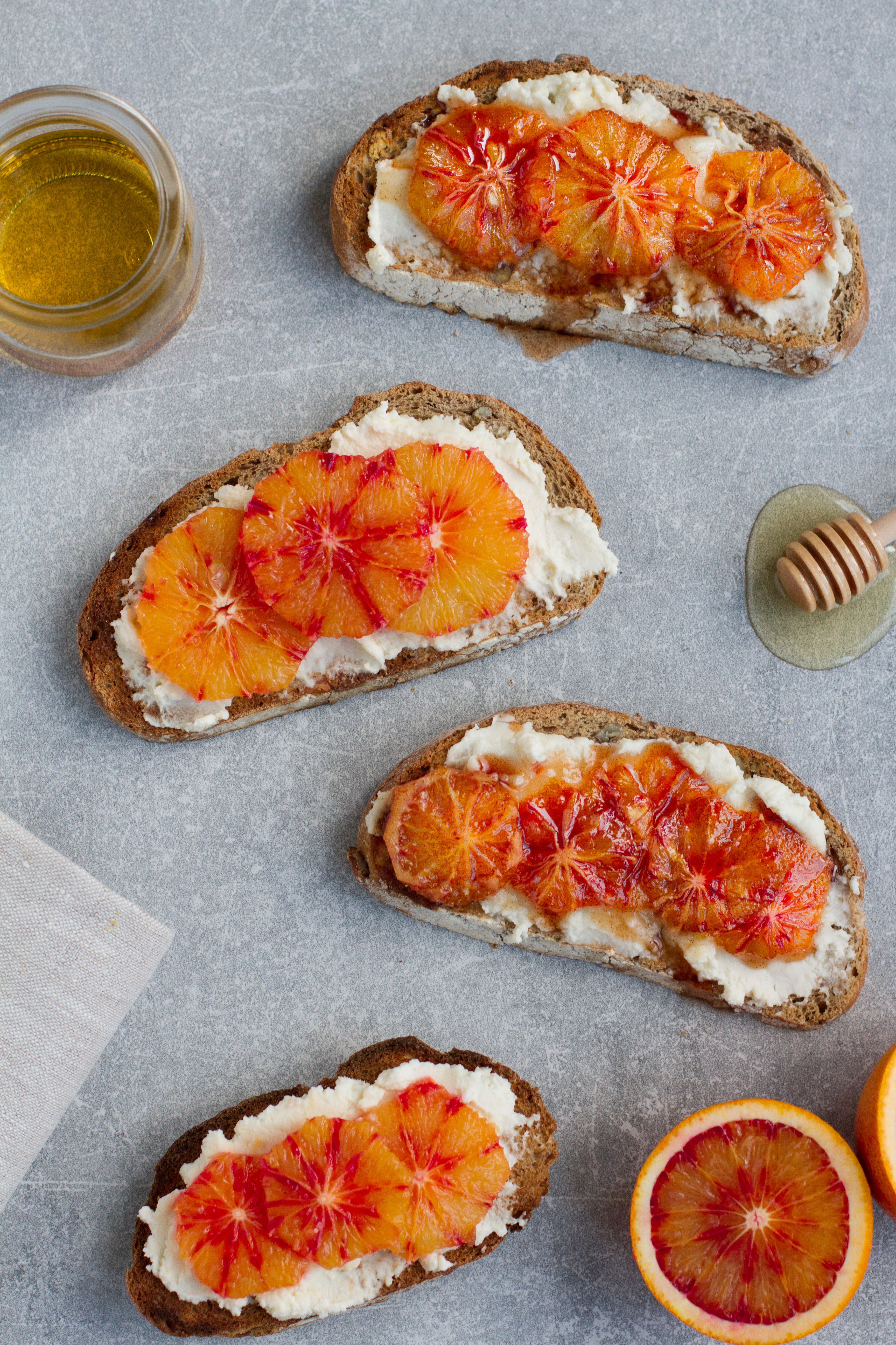vegan blood orange breakfast toast with cream cheese, agave, pistachio and pomegranate