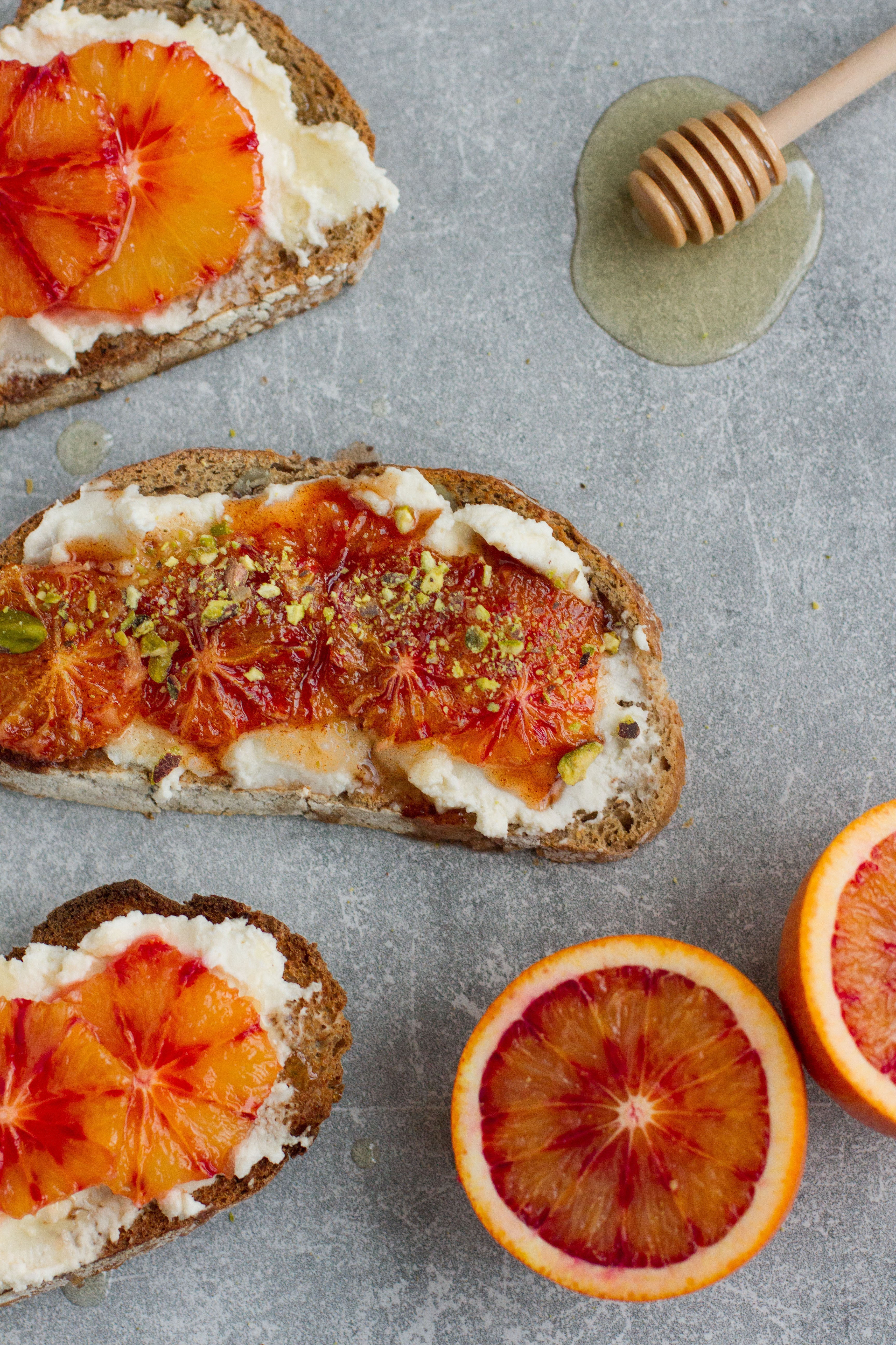 vegan blood orange breakfast toast with cream cheese, agave, pistachio and pomegranate