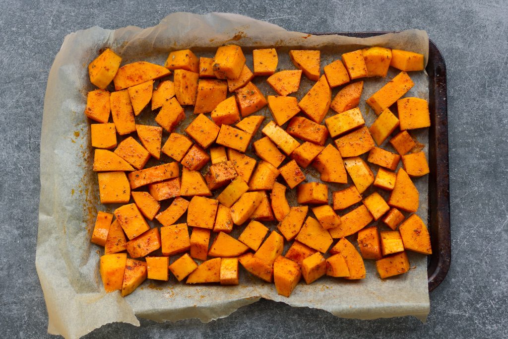 butternut squash chunks on sheet pan, ready to be roasted