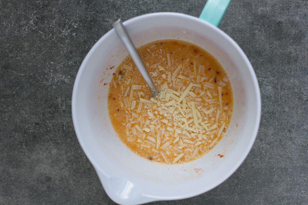 mixing cheese and eggs in a large bowl