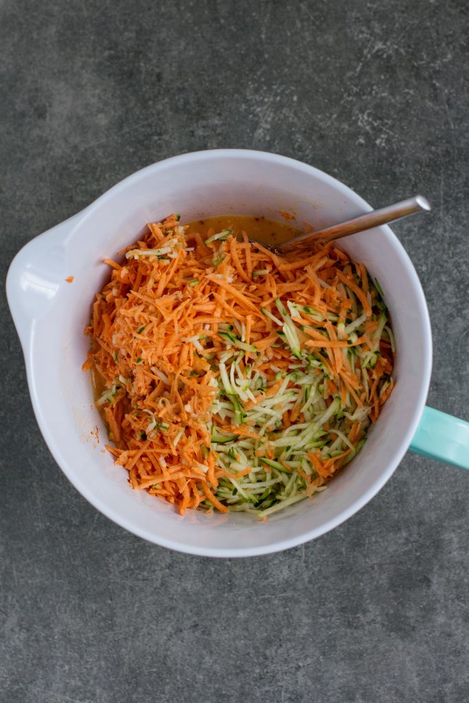 shredded sweet potato and courgette in bowl with egg