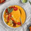 herby butternut squash polenta topped with roasted tomatoes and avocado